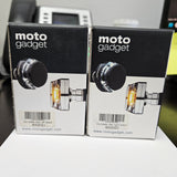 Two boxes of 'moto gadget' on a light gray background