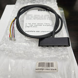 Electronic device with cable on a bubble-wrapped surface, brand 'motogadget' visible